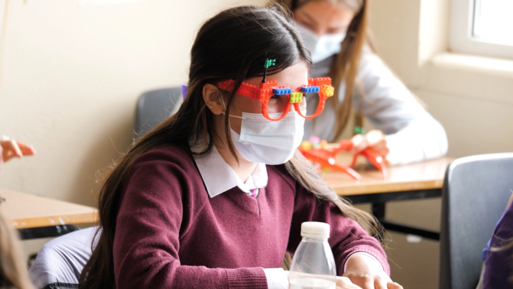 School student wearing mask and Lego glasses