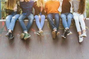 Young people sitting on a wall