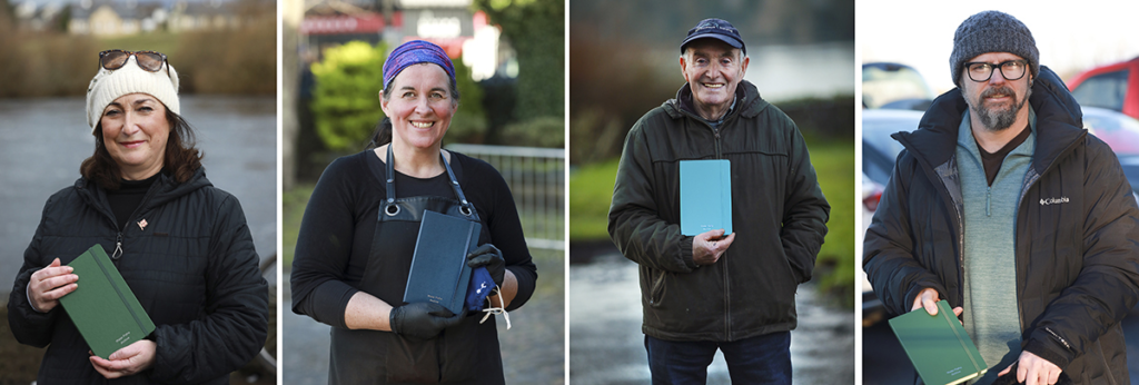 4 people holding notebooks