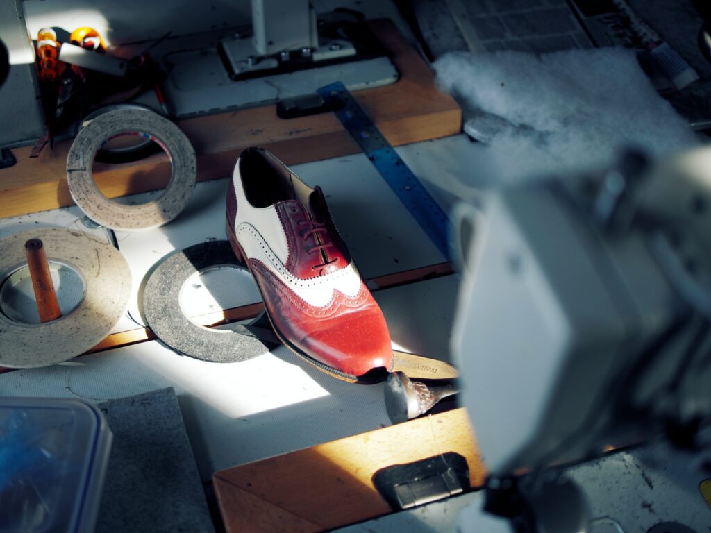 Freshly made leather man's shoe at shoemaker workshop