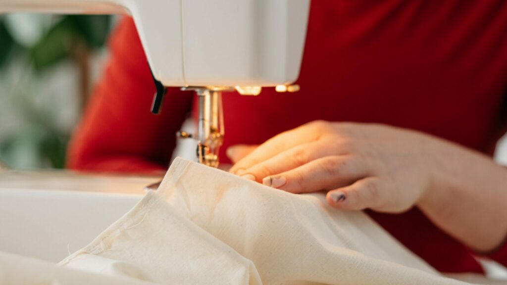 Hands using sewing machine