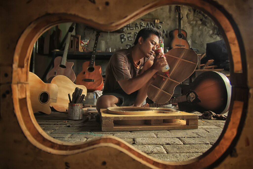 Man repairing guitar