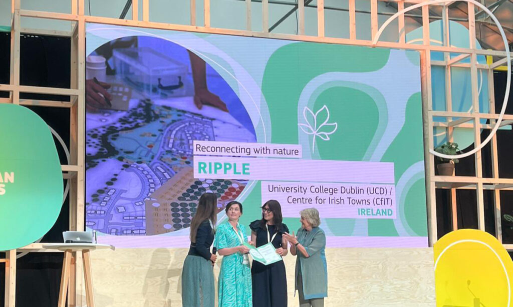 Four women accept an award on stage